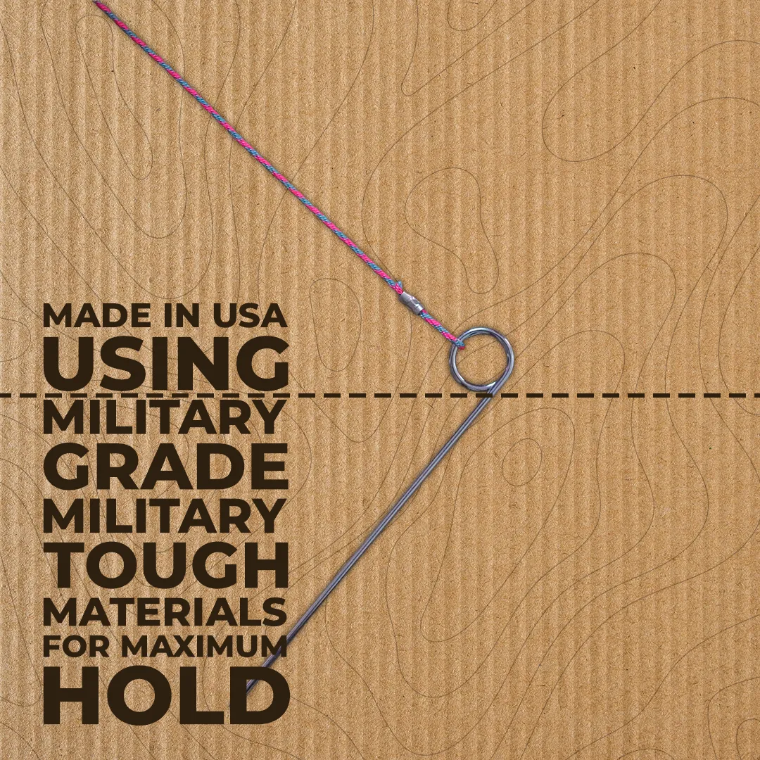 Metal fishing hook attached to pink and blue braided fishing line on a textured cardboard background with text about military-grade materials.